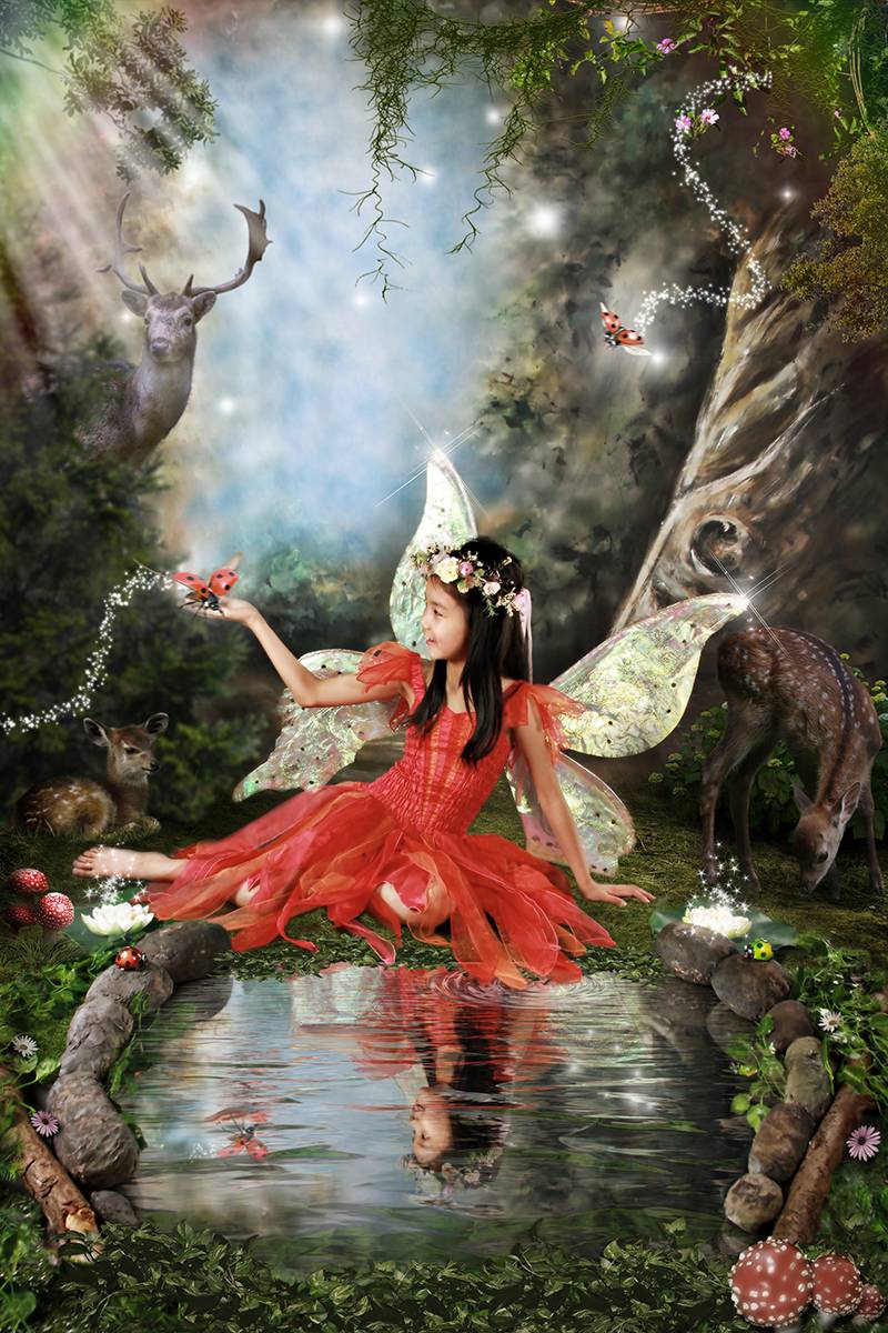 Little girl fairy by a pond in a magical, enchanted forest