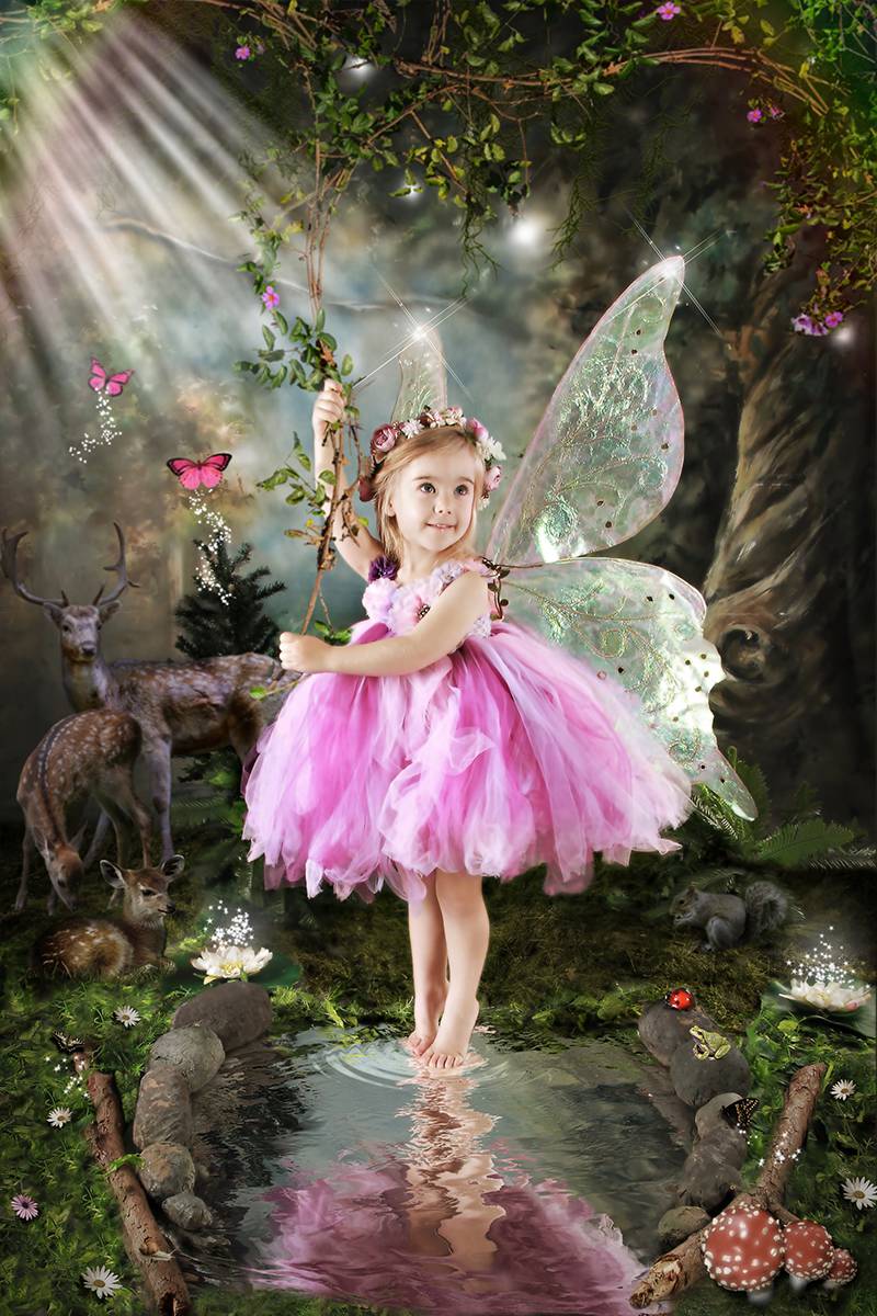 Little girl fairy by a pond in a magical, enchanted forest